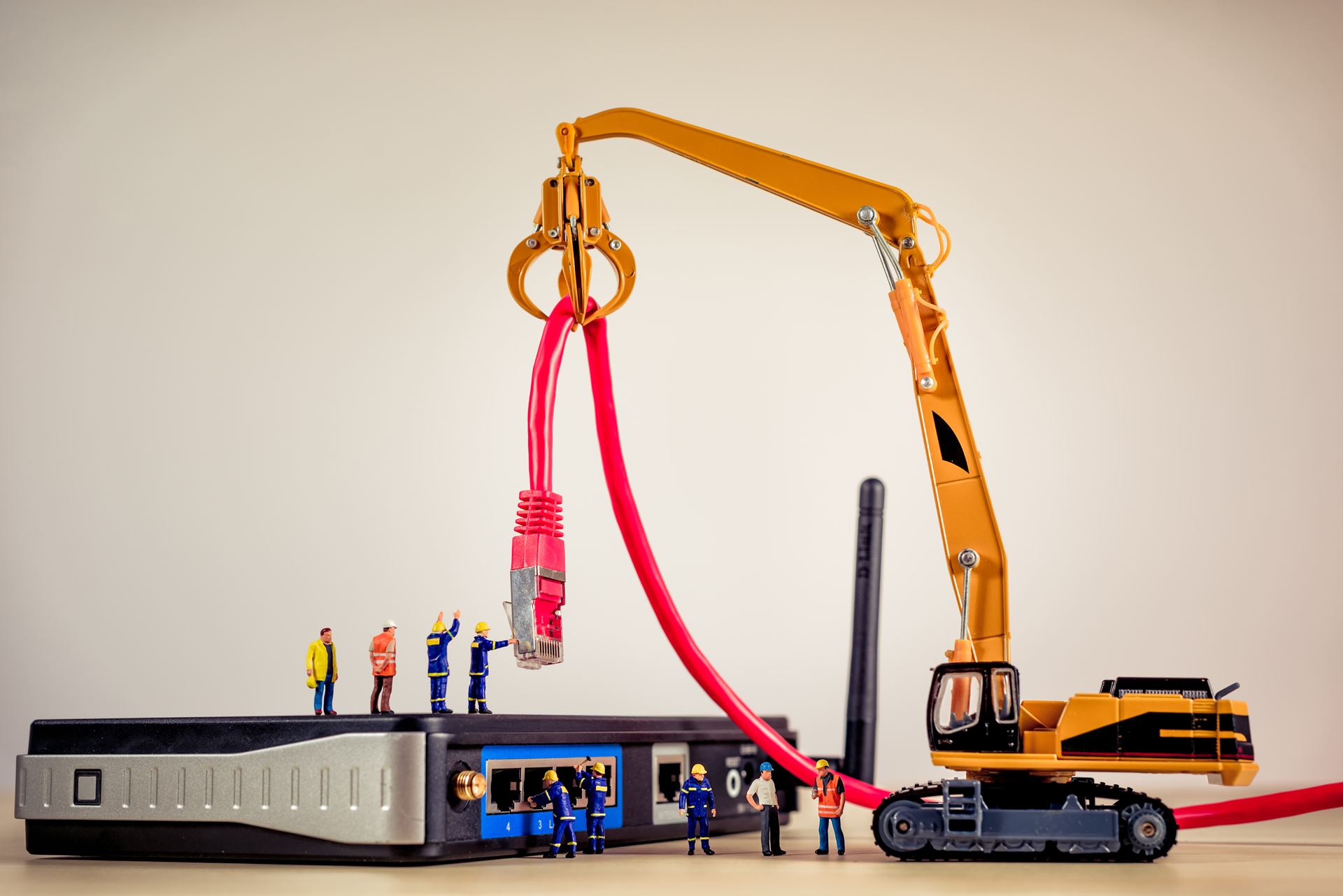 Technical support engineers working on a network installation with a crane and router